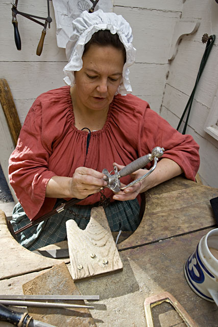 Suzie Dye works on a sword hilt in the James Geddy Foundry.