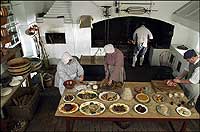 Members of the Historic Foodways department prepare food in the kitchen of the Governor's Palace.
