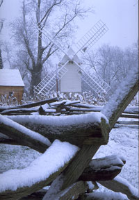 Robertson's Windmill stands silent in the snow with sails removed from the blades. 
