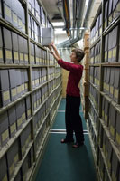 In the foundation's archives, Donna Cooke shelves materials in a cli- mate-controlled room.