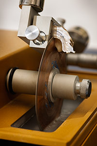 Oyster-shell specimens are sectioned by a 
spinning blade, allowing anthropologists to examine details on 
a microscope slide.