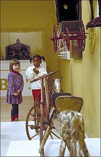 Children viewing an antique toy exhibit