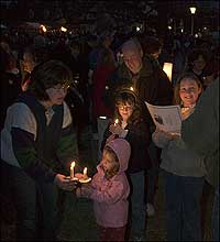 Famillies singing by candlelight