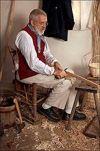 Colonial Williamsburg basketmaker Richard Carr working white oak into strips.