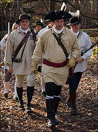 Richard Schumann as Patrick Henry leads Justin Chapman, left, Ken Treese, right, and the Hanover militia in a march on Williamsburg.