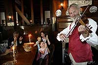 A tavern fiddle player delights his audience
