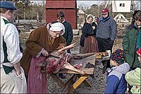 An interpreter butchers a hog