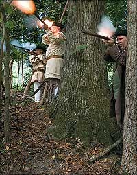 The popular image of militia in the Revolution was of sniping from the woods at British soldiers in the open. Behind the trees, Richard Frazier, George Suiter, and Richard Sullivan, from left, pick off the redcoats. Such action seldom occurred.