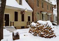 Cordwood stacked near colonial homes and buildings—here Colonial Williamsburg’s Golden Ball—feeds Historic Area fireplaces. 