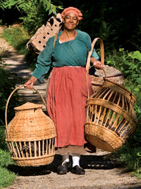 Chicken in a basket: Janice Canaday carries Dominique chickens home to roost, and, opposite, Elaine Shirley feeds them.