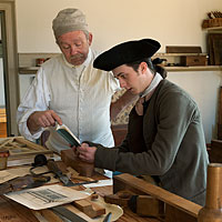 David Salisbury as a master teaching his apprentice, Levi Walker, to read, as apprenticeship contracts required.