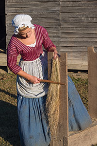 A scutching board and knife are used to smooth the flax.