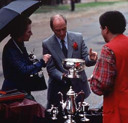 Prime Ministers Margaret Thatcher and Pierre Trudeau with silversmith Jimmy Curtis, 1983.- Colonial Williamsburg