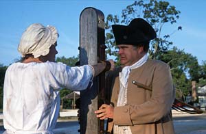 In eighteenth-century Williamsburg, morals offenses were often paid for under the lash at the stocks and pillory. Interpreters Karen Clancey and Steve Holloway portray such an encounter. - Dave Doody