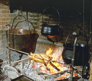 The iron pots hanging in the fireplace might with justice call the sooty copper kettle black, or little better than they