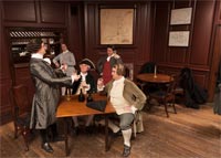 In 1752, the Reverend Mr. William Stith presented a tavern toast to life and liberty, and a small gold coin called a pistole, to protest against an arbitrary government fee. Todd Norris, left, as Stith, with Jason Belew, Chris Allen, Bryan Austin, and Jay Knowlton recreate the scene.