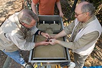 Colonial Williamsburg archaeologists use a flotation tank to capture seeds from archaeological soil samples.