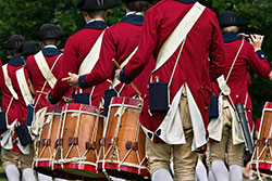 Audiences at performances see only straight lines, smart marching and authentic uniforms 
and instruments.