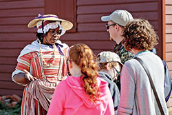 Edith Cumbo, portrayed by Emily James, can be seen conversing with guests in the Historic Area.