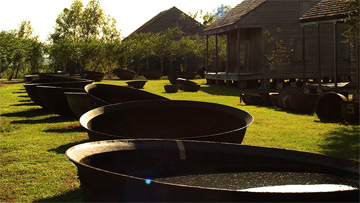 Credit: Whitney Plantation Sugar kettles and slave cabins