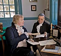 Partly on the advice of Secretary of State Thomas Jefferson, who figured things differently, President George Washington vetoed the first attempt at apportionment. Interpreters Bill Barker, left, as Jefferson, and Ron Carnegie as Washington run the numbers.