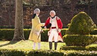 Colonial Williamsburg's Lord Dunmore played by Dennis Watson, and Benedict Arnold played by Scott Green talk in the gardens of the Governor's Palace.