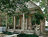 One of the four remaining offices among the Historic Area’s original eighteenth-century buildings, the Benjamin Powell Office, with interpreter Gina Conroy sitting on its porch. For professionals, offices allowed formal separation of work and family life.