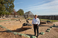 Author Kelso stands inside the excavated 1607 fort at Jamestown, long thought to have washed into the James River.