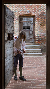 Entering the gaol in irons, interpreter Dan Moore as a miscreant who could face death for stealing a handkerchief.
