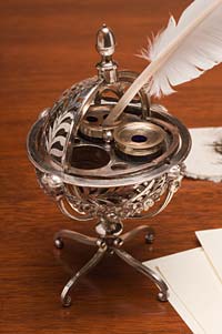 A silver globe inkstand, ca. 1795, with bottles for ink, sand, and quills, from the Colonial Williamsburg collections.