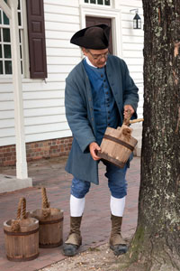 Colonial Williamsburg’s Historic Gardener Wesley Greene reenacts the tapping process.