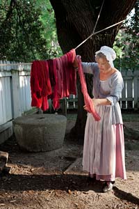 The wool in varying shades of red is hung to dry.