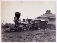 Locomotive J.H. Devereux outside the roundhouse at the Alexandria, Va., station, circa 1857-1865.