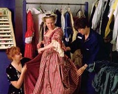 It's time for Martha Washington's final fitting. Guenivere Lee (left) and Frances Loba (right) check Susan Berquist's new gown.