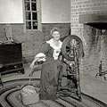 1947 - Bonnie Brown spins wools on a spinning wheel in the George Wythe South Office